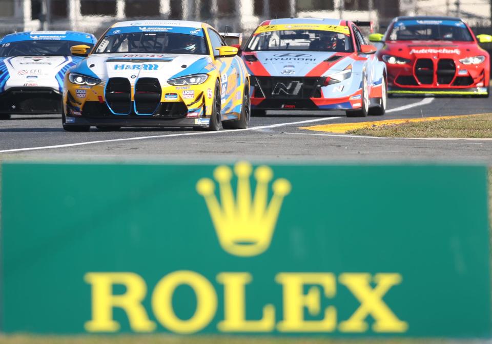 A pack of cars race through the horseshoe during Michelin Pilot Challenge practice at the Roar Before the Rolex 24.