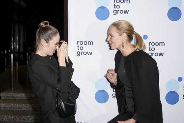 <p>John Nacion/Variety via Getty</p> Maya Hawke takes a photo of mom Uma Thurman at Room To Grow's 25th Anniversary Gala held at the Ziegfeld Ballroom on October 25, 2023 in New York City.