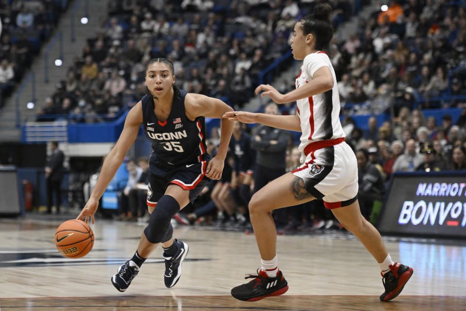 Connecticut's Azzi Fudd, left, is guarded by NC State's Madison Hayes, right during the first half of an NCAA basketball game, Sunday, Nov. 20, 2022, in Hartford, Conn. (AP Photo/Jessica Hill)