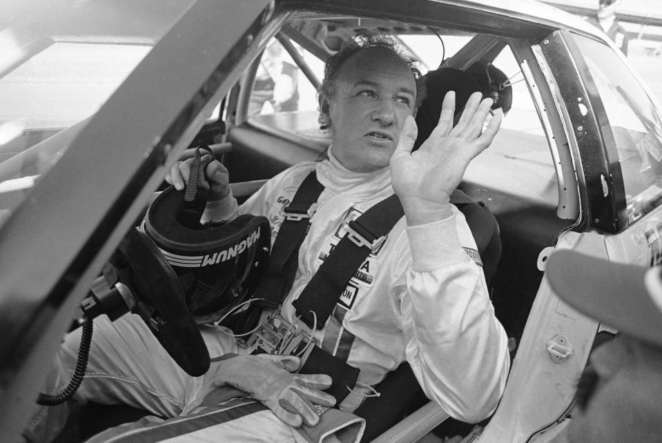 Actor Gene Hackman waves as he starts out for a practice run in his Toyota Celica, Feb. 5, 1983 at the Daytona International Speedway in preparation for the Daytona 24 Hour Endurac Race. This race marks the start of Hickman?s career as a professional driver. (AP Photo/Bob Self)