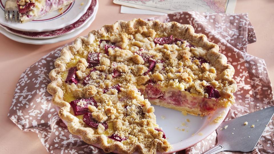 rhubarb custard pie in a pie plate with a slice removed to show the inside