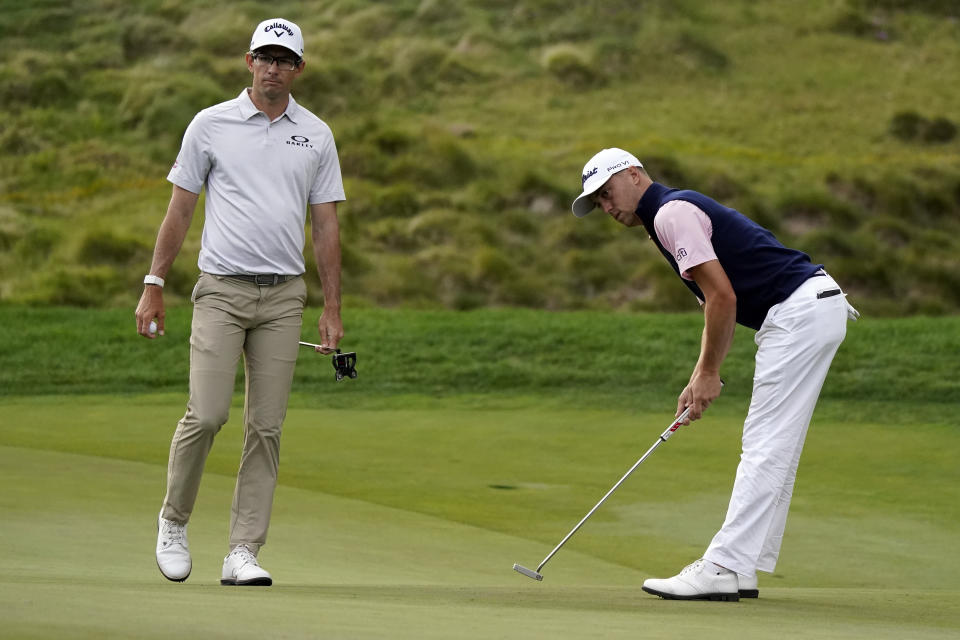 Justin Thomas, right, reacts after putting on the 18th hole next to Dylan Frittelli during the third round of the Zozo Championship golf tournament Saturday, Oct. 24, 2020, in Thousand Oaks, Calif. (AP Photo/Marcio Jose Sanchez)