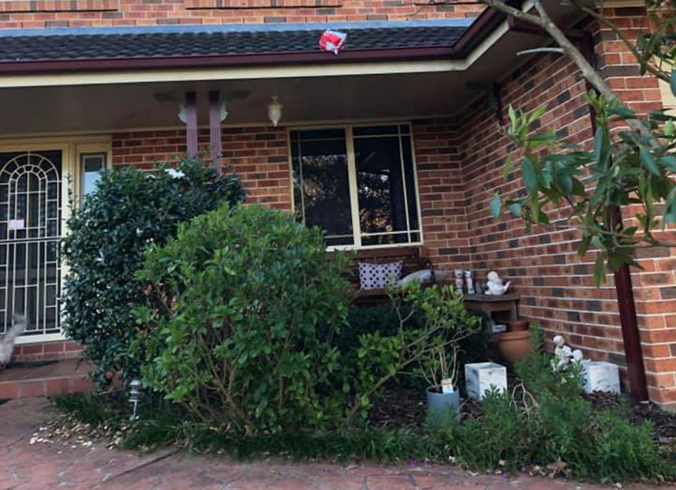 Pictured is an Australia Post parcel in a roof gutter. A Castle Hill woman claims Australia Post delivered her parcel to her by throwing it on her roof.