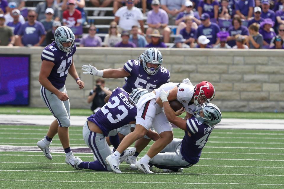 Kansas State linebacker Austin Romaine (45), defensive tackle Damian Ilalio (56) and linebacker Asa Newsom (23) combine to bring down Troy quarterback Goose Crowder (9) during their Sept. 9 game at Bill Snyder Family Stadium.