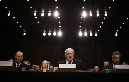 U.S. Director of National Intelligence James Clapper (C ) testifies alongside National Security Agency Director General Keith Alexander (L) and Deputy Attorney General James Cole at a Senate Intelligence Committee hearing the Foreign Intelligence Surveillance Act legislation on Capitol Hill in Washington, September 26, 2013. REUTERS/Jason Reed (UNITED STATES - Tags: POLITICS)