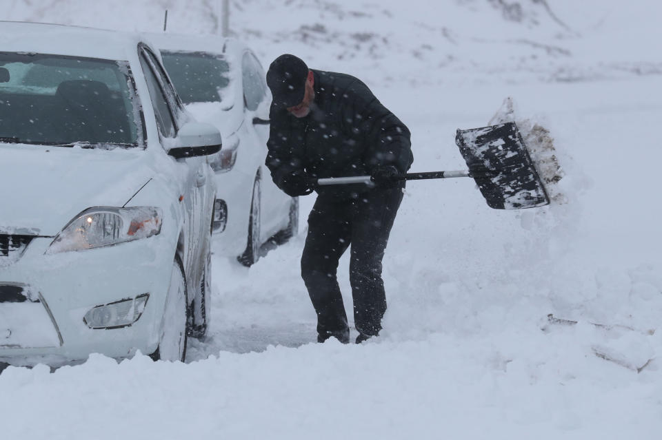 A man clears snow from a car in Larbert as storm Emma, rolling in from the Atlantic, looks poised to meet the Beast from the East's chilly Russia air - causing further widespread snowfall and bitter temperatures.