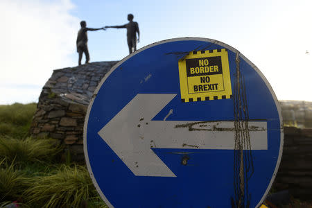 FILE PHOTO: A ' No Border, No Brexit' sticker is seen on a road sign in front of the Peace statue entitled 'Hands Across the Divide' in Londonderry, Northern Ireland, January 22, 2019. REUTERS/Clodagh Kilcoyne