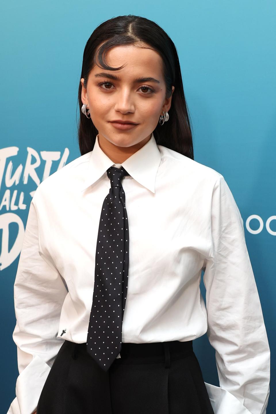 Isabela Merced in white shirt, black tie, and trousers at 'Turtles All the Way Down' event