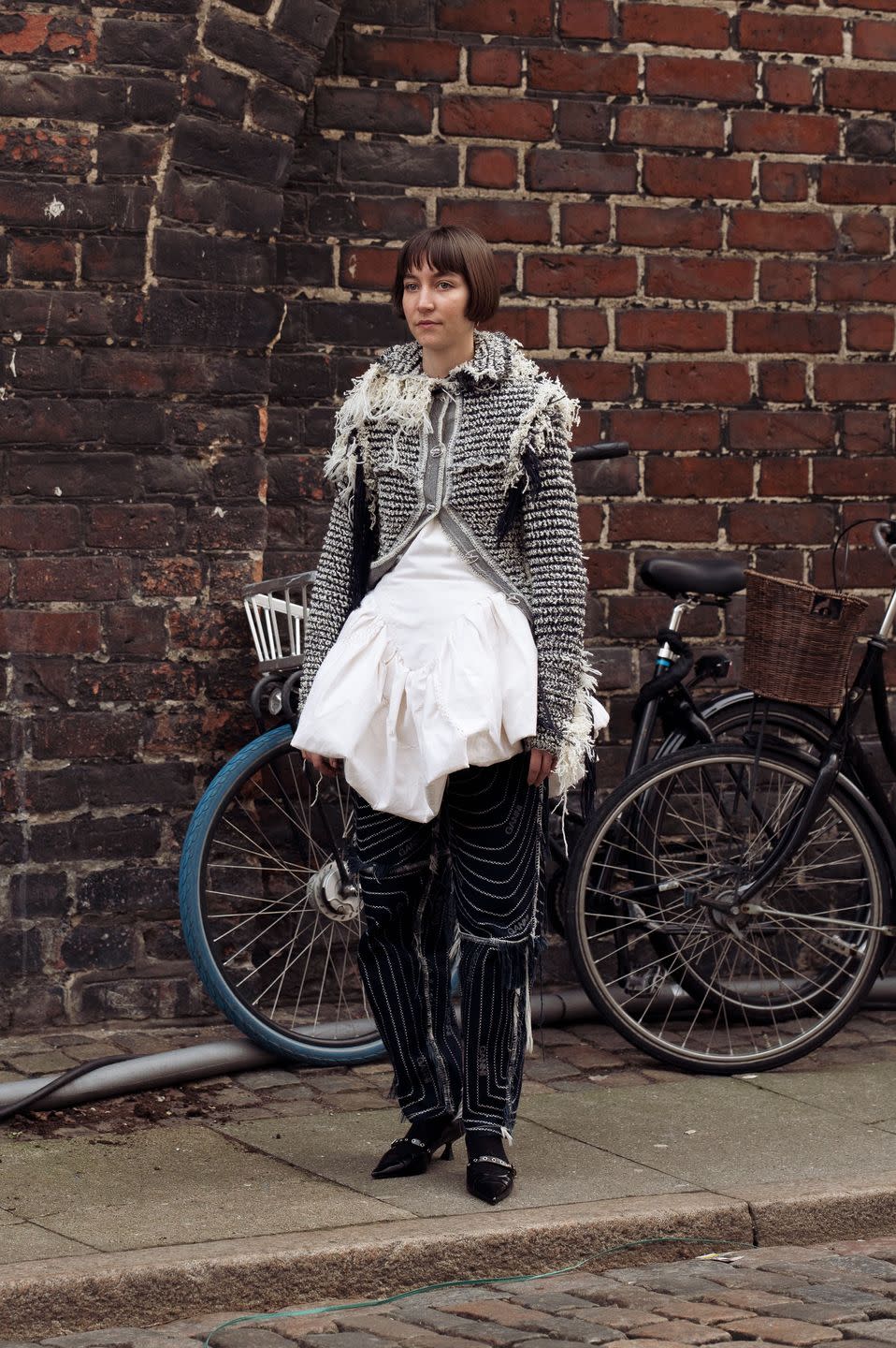 copenhagen, denmark january 29 a guest is wearing black pants, white mini dress, black and white jacket during the copenhagen fashion week aw24 on january 29, 2024 in copenhagen, denmark photo by raimonda kulikauskienegetty images