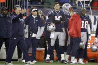 New England Patriots head coach Bill Belichick, left, offensive coordinator Josh McDaniels, center, and quarterback Tom Brady watch the final minute of an NFL wild-card playoff football game loss to the Tennessee Titans, Saturday, Jan. 4, 2020, in Foxborough, Mass. (AP Photo/Steven Senne)