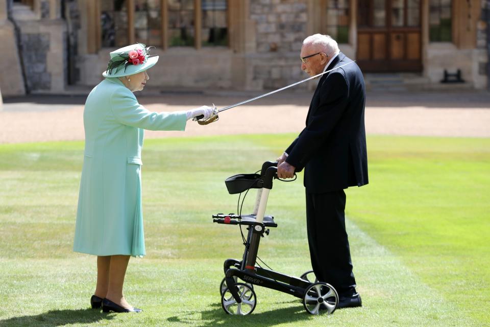 The Queen knights Moore at Windsor Castle in July last yearAFP/Getty