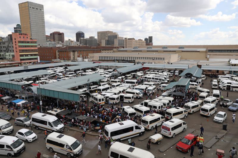 Passengers are seen at taxi rank as residents of a number of African cities where the coronavirus is spreading are heading to the countryside to try to escape from the disease, in Johannesburg