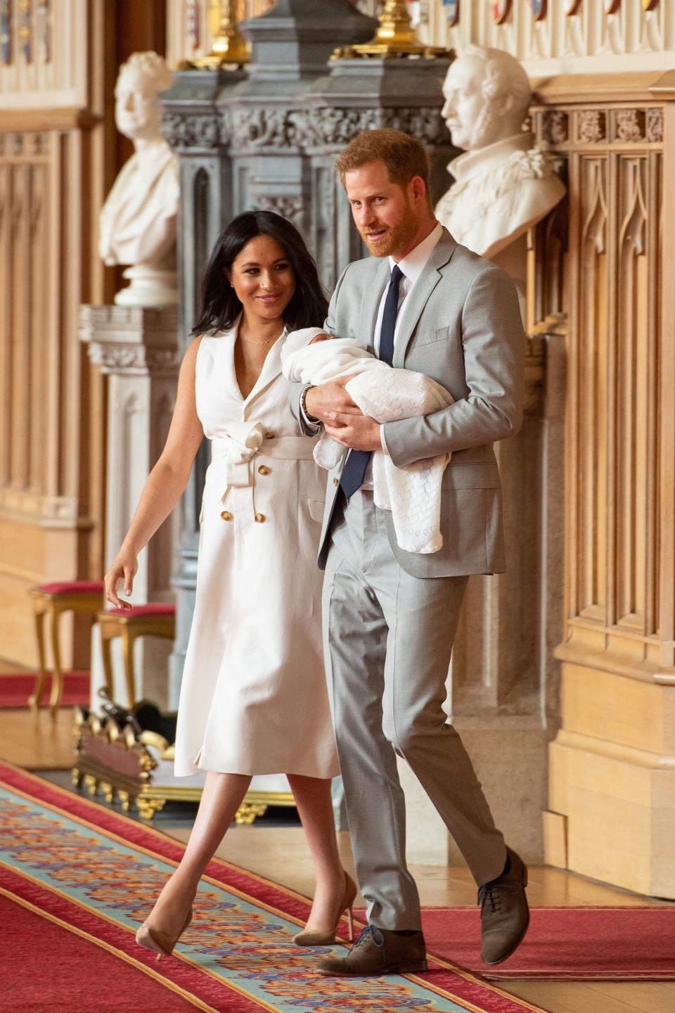 Britain's Prince Harry, Duke of Sussex (R), and his wife Meghan, Duchess of Sussex, pose for a photo with their newborn baby son, Archie Harrison Mountbatten-Windsor, in St George's Hall at Windsor Castle in Windsor, west of London on May 8, 2019. (Photo by Dominic Lipinski / POOL / AFP)        (Photo credit should read DOMINIC LIPINSKI/AFP via Getty Images)