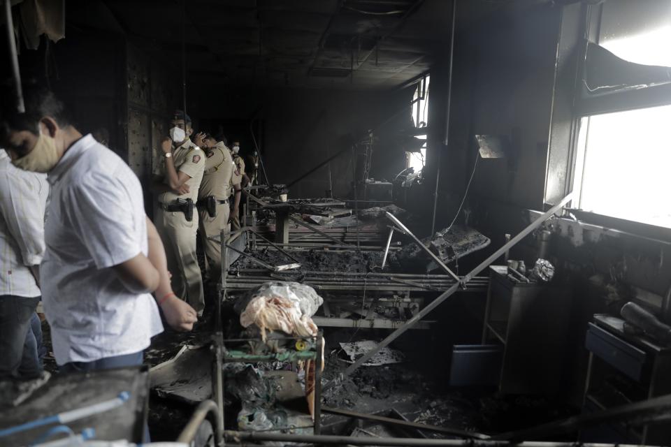 People inspect an ICU ward after a fire broke out in Vijay Vallabh COVID-19 hospital at Virar, near Mumbai, India, Friday, April 23, 2021. A fire killed 13 COVID-19 patients in a hospital in western India early Friday as an extreme surge in coronavirus infections leaves the nation short of medical care and oxygen. (AP Photo)