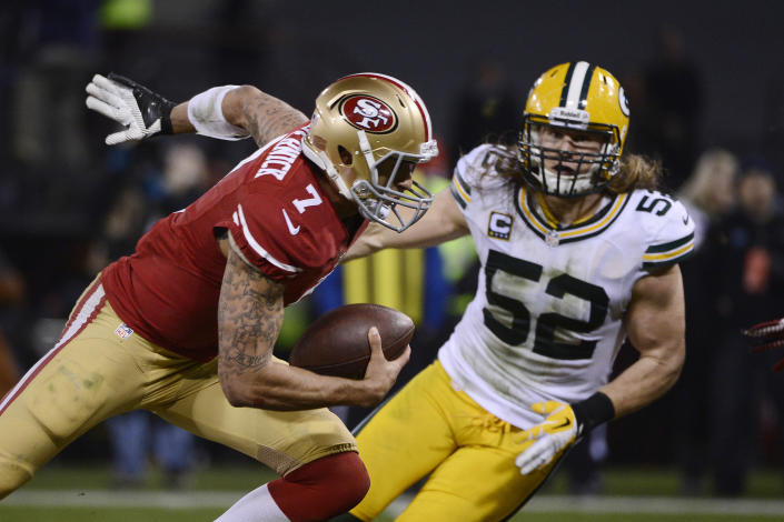 Colin Kaepernick carries the ball on his tattoo-covered right arm against the Packers. (USA Today Images). 