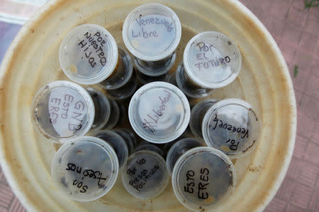 Messages are seen on plastic containers filled with feces, called "Poopootovs", which is a play on Molotov cocktails, before they are thrown at security forces during protests, in addition to the usual rocks and petrol bombs, in Caracas, Venezuela May 9, 2017. REUTERS/Christian Veron