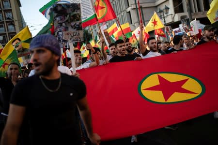 Kurds living in Greece shout slogans during a demonstration against Turkey's military action in northeastern Syria, in Athens