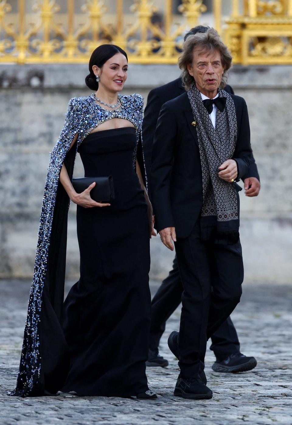 Rolling Stones band member Mick Jagger and Melanie Hamrick arrive to attend a state dinner in honor of Britain's King Charles and Queen Camilla at the Chateau de Versailles (Reuters)