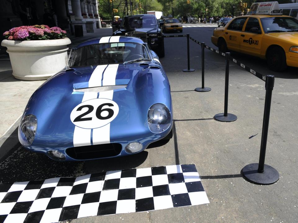 Shelby Daytona Cobra Coupe parked on street in New York City as yellow cab drives by