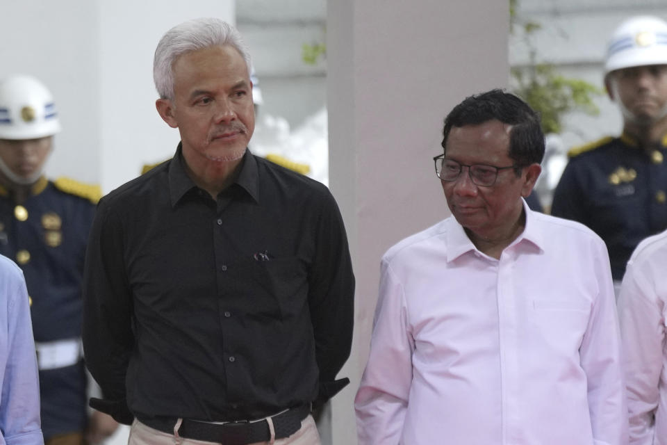 Presidential candidate Ganjar Pranowo, left, and his running mate Mahfud MD stand on the stage during the signing ceremony of the "Declaration of Peaceful Election Campaign" at the General Election Commission Building in Jakarta, Indonesia, Monday, Nov. 27, 2023. Indonesia's presidential hopefuls vowed a peaceful race on Monday, a day before campaigning for next year's election officially began as concerns rose their rivalry may sharpen religious and ethnic divides in Southeast Asia's largest democracy. (AP Photo/Tatan Syuflana)