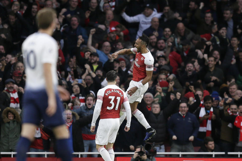 Arsenal's Pierre-Emerick Aubameyang, right, celebrates after scoring his side's second goal during the English Premier League soccer match between Arsenal and Tottenham Hotspur at the Emirates Stadium in London, Sunday Dec. 2, 2018. (AP Photo/Tim Ireland)