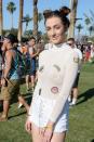 A Coachella attendee paired her double knots with big hoop earrings and a sheer top adorned with patches.