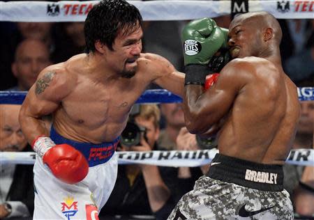 Apr 12, 2014; Las Vegas, NV, USA; Timothy Bradley (green gloves) and Manny Pacquiao (red gloves) box during their WBO World Welterweight Title bout at MGM Grand Garden Arena. Pacquiao won via unanimous decision. Mandatory Credit: Joe Camporeale-USA TODAY Sports