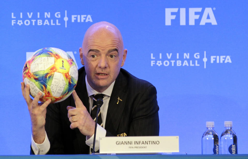 FIFA President Gianni Infantino holds a soccer ball as he speaks during a press conference after the FIFA Council Meeting, Friday, March 15, 2019, in Miami. The council approved working with Qatar to explore expanding the 2022 World Cup to 48 teams by adding at least one more country in the Persian Gulf to host matches. (AP Photo/Luis M. Alvarez)