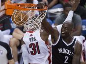 Brooklyn Nets forward Kevin Garnett, right, dunks against the Toronto Raptors during the second half of Game 2 in an NBA basketball first-round playoff series, Tuesday, April 22, 2014, in Toronto. (AP Photo/The Canadian Press, Nathan Denette)