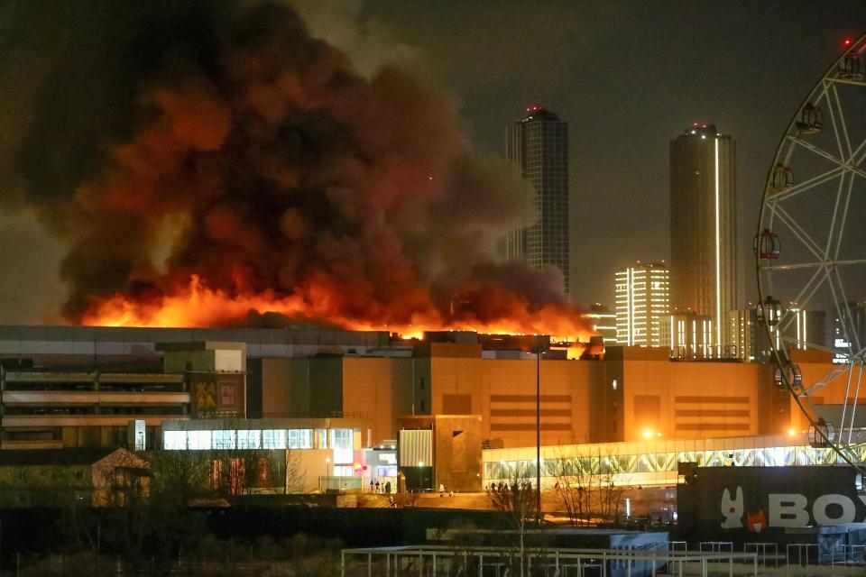 A massive blaze is seen over the Crocus City Hall on the western edge of Moscow, Russia, March 22, 2024, afters gunmen burst into the concert venue and fired automatic weapons at the crowd before setting a massive blaze. / Credit: Sergei Vedyashkin/AP