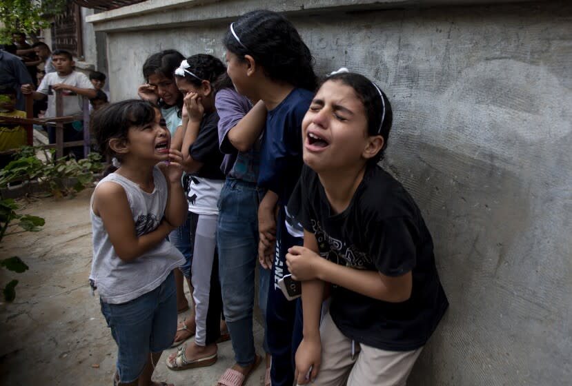 Mourners react during the funeral of Palestinian Tamim Hijazi, who was killed in an Israeli air strike, in Khan Yunis in the southern Gaza Strip, Saturday, Aug. 6, 2022. Israeli jets pounded militant targets in Gaza as rockets rained on southern Israel, hours after a wave of Israeli airstrikes on the coastal enclave killed at least 11 people, including a senior militant and a 5-year-old girl. The fighting began with Israel's dramatic targeted killing of a senior commander of the Palestinian Islamic Jihad continued into the morning Saturday, drawing the sides closer to an all-out war. (AP Photo/Yousef Masoud)