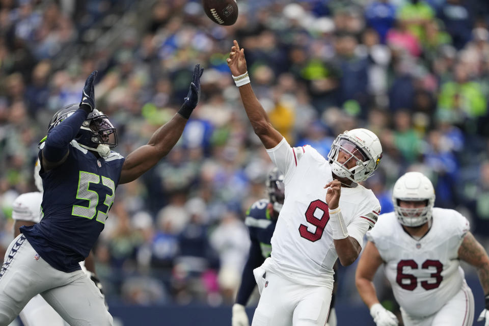 Arizona Cardinals quarterback Joshua Dobbs (9) gets off a pass while under pressure from Seattle Seahawks linebacker Boye Mafe (53) as Cardinals center Trystan Colon (63) looks on during the second half of an NFL football game Sunday, Oct. 22, 2023, in Seattle. (AP Photo/Lindsey Wasson)