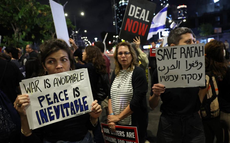 Relatives and supporters of hostages taken captive by Palestinian militants in Gaza during the October 7 attacks, hold placards and wave national flags during a demonstration calling for their release, in the Israeli coastal city of Tel Aviv on May 6, 2024, amid the ongoing conflict in the Gaza Strip between Israel and the Palestinian militant Hamas group.