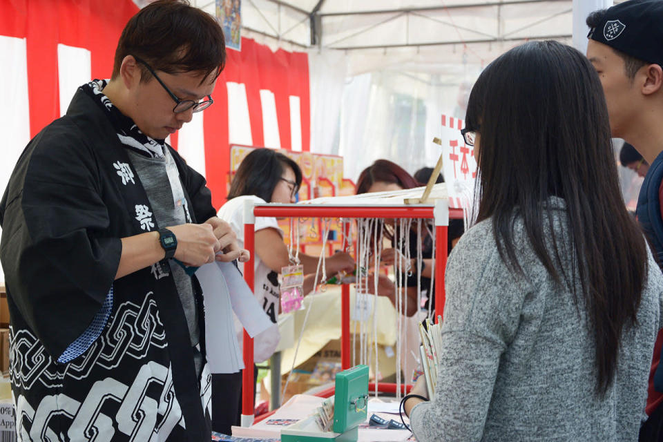 People buying coupons to play the festival games. (Photo: Sharlene Sankaran/Yahoo Singapore)