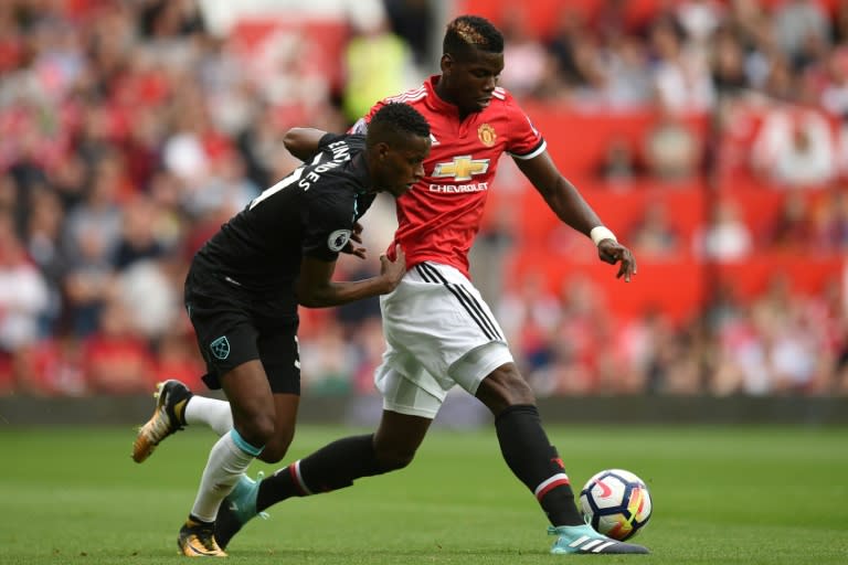 West Ham United's midfielder Edimilson Fernandes (L) vies with Manchester United's midfielder Paul Pogba during the English Premier League football match August 13, 2017