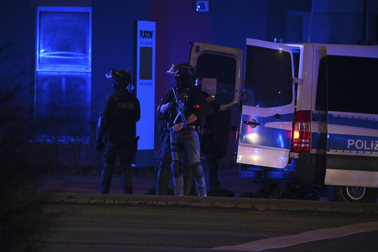 Armed police officers near the scene of a shooting in Hamburg, Germany on Thursday March 9, 2023 after one or more people opened fire in a church. The Hamburg city government says the shooting took place in the Gross Borstel district on Thursday evening. (Jonas Walzberg/dpa via AP)