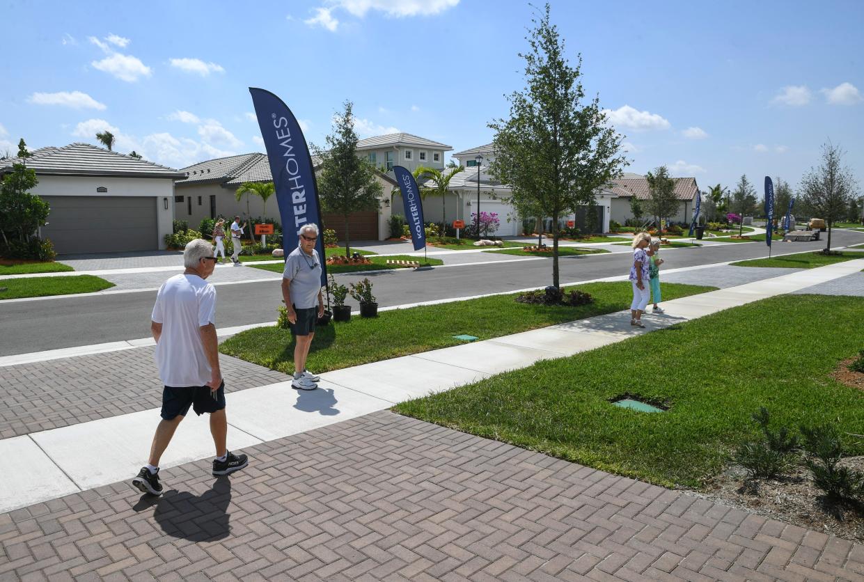 Scott Ferguson (from left) and his father-in-law Cleo Pelletier, walk through the Kolter Homes model homes with their wives Bea Ferguson and Lorraine Pelletier on Monday, March 13, 2023,  in the PGA Verano community in Port St. Lucie. Explosive growth in population and the housing market has builders manufacturing new homes in the west side of Port. St. Lucie in the Tradition area.