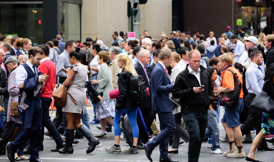 People crossing street as unemployment figures are released.