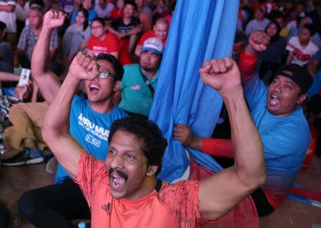 Supporters of Mahathir Mohamad, former Malaysian prime minister and opposition candidate for Pakatan Harapan (Alliance of Hope), celebrate outside the hotel, where Mahathir Mohamad held news conference, in Petaling Jaya, Malaysia, May 10, 2018. REUTERS/Athit Perawongmetha