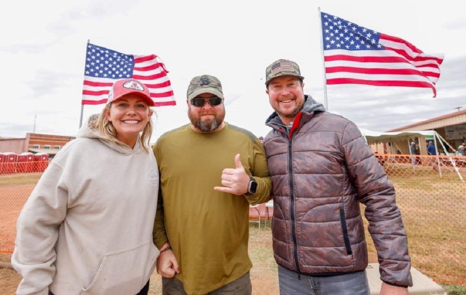 Becky Daniel, who serves on the Big Country Veterans Weekend Board, veteran Mark Little and race car driver Kurt Busch greet veterans at the Circle Bar Ranch this past weekend for the veterans’ helicopter hog hunt.