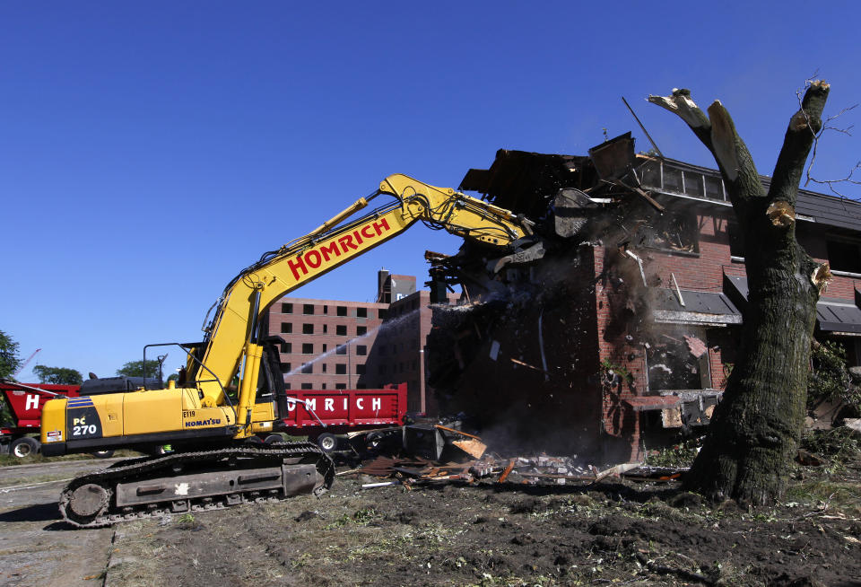 The first stage of demolishing the Frederick Douglass Homes begins in Detroit, Wednesday, Sept. 4, 2013. The graffiti-covered complex comprising several city blocks is better known as the Brewster projects. A $6.5 million emergency federal grant covers the initial phase of demolition and cleanup, and officials say the city will be eligible for more money when that’s completed. The federal money comes at a crucial time for the city, which is overseen by a state-appointed emergency manager and in July became the nation’s largest city to file for bankruptcy. (AP Photo/Paul Sancya)