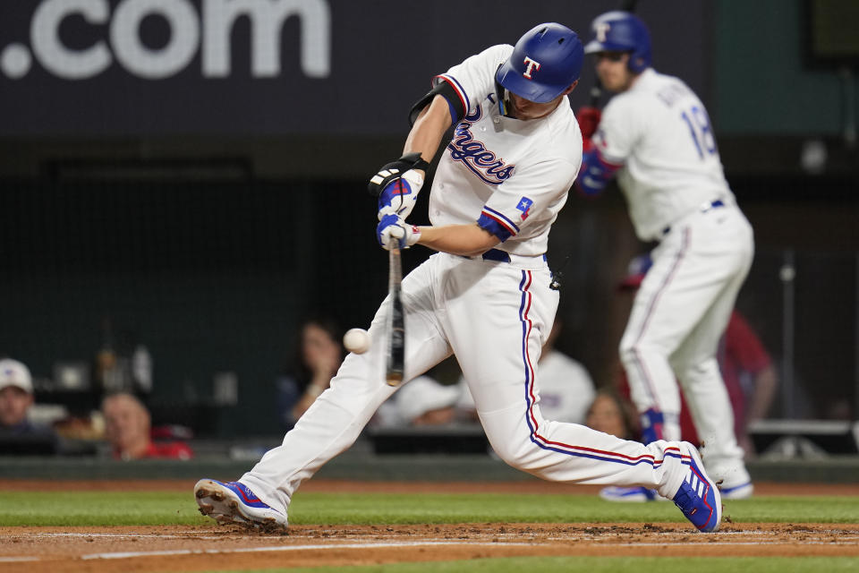 Texas Rangers' Corey Seager hits a solo home run in the first inning of Game 3 of a baseball AL Division Series against the Baltimore Orioles on Tuesday, Oct. 10, 2023, in Arlington, Texas. (AP Photo/Julio Cortez)