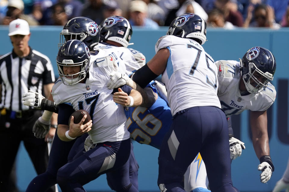Tennessee Titans quarterback Ryan Tannehill is pressured by Los Angeles Chargers defensive end Morgan Fox (56) during the second half of an NFL football game Sunday, Sept. 17, 2023, in Nashville, Tenn. (AP Photo/George Walker IV)