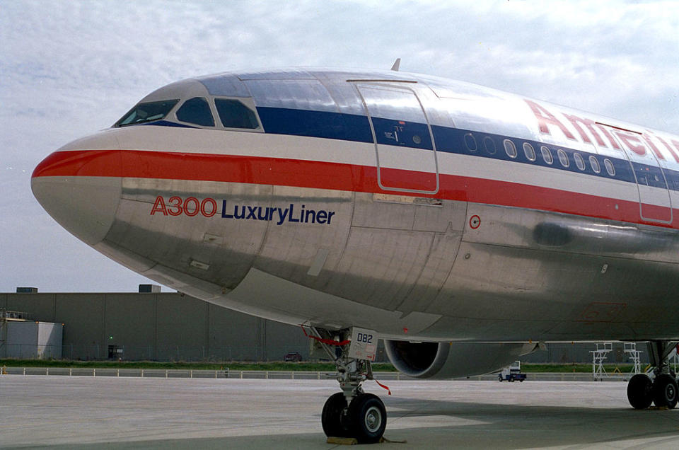 Front view of an American Airlines A300 LuxuryLiner aircraft parked at an airport gate