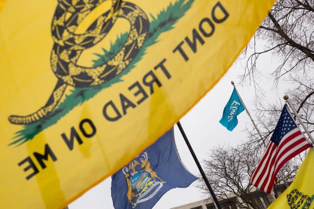 Gadsden flags surround Flint, Michigan, and United States flags during a rally at Flint City Hall on Jan. 24, 2016. The event was organized by Genesee County Volunteer Militia to protest corruption they see in government related to the Flint water crisis that resulted in a federal state of emergency.