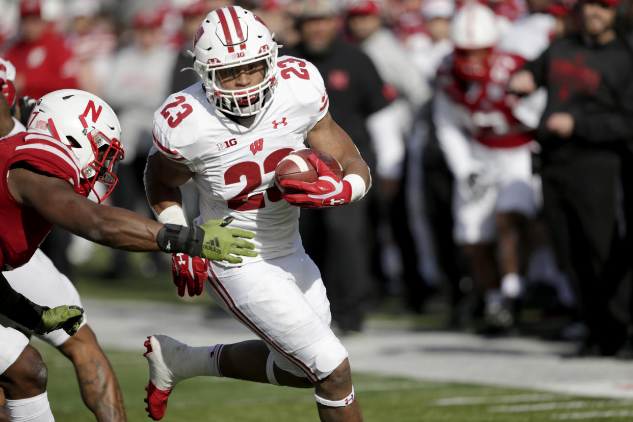 Wisconsin running back Jonathan Taylor (23) runs for a touchdown against Nebraska linebacker Mohamed Barry, left, during the first half of an NCAA college football game in Lincoln, Neb., Saturday, Nov. 16, 2019. (AP Photo/Nati Harnik)