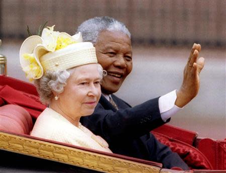 South Africa's President Nelson Mandela and Britain's Queen Elizabeth ride in a carriage outside Buckingham Palace on the first day of a state visit to Britain, in this July 9, 1996 file photo. REUTERS/Stringer/Files