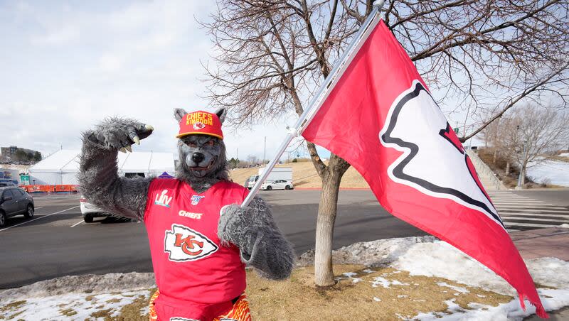 A Kansas City Chiefs fan, Chiefsaholic, poses for photos while walking toward Empower Field at Mile High before an NFL football game between the Denver Broncos and the Chiefs Saturday, Jan. 8, 2022, in Denver.