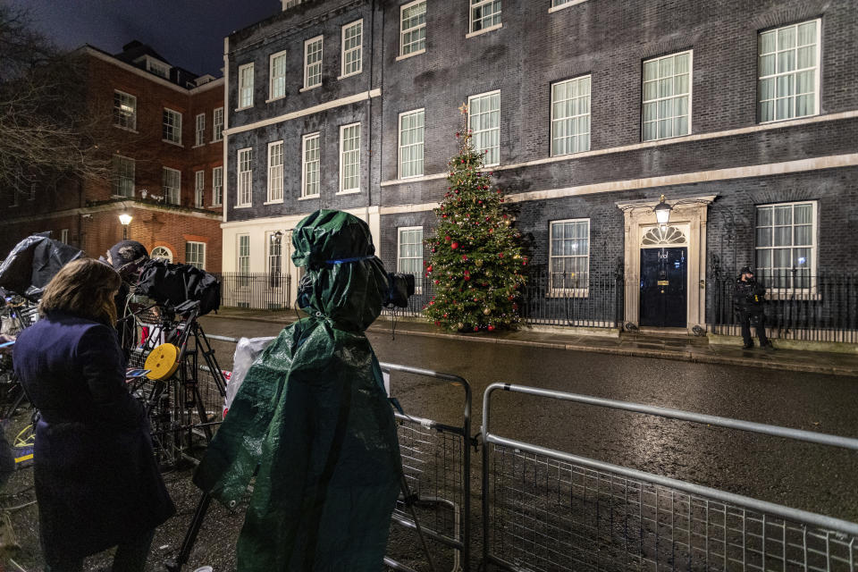 Media stand opposite 10 Downing Street, just before voting closed for the 2019 General Election, Thursday, Dec. 12, 2019. An exit poll in Britain’s election projects that Prime Minister Boris Johnson’s Conservative Party likely will win a majority of seats in Parliament. That outcome would allow Johnson to fulfill his plan to take the U.K. out of the European Union next month. (AP Photo/Vudi Xhymshiti)