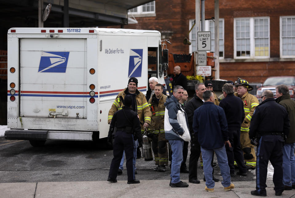 Law enforcement and other emergency personnel gather outside a post office Friday, Jan. 31, 2014, in Rutherford, N.J. White powder was mailed to businesses near the site of Sunday's Super Bowl, prompting an investigation by the FBI and other law enforcement. A federal law enforcement official said one of the envelopes contained baking soda. (AP Photo/Jeff Roberson)